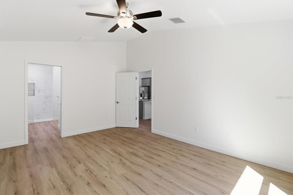 13418 Cormorant Road Weeki Wachee, FL 34614 - Photo 31 of 46 a view of an empty room with wooden floor