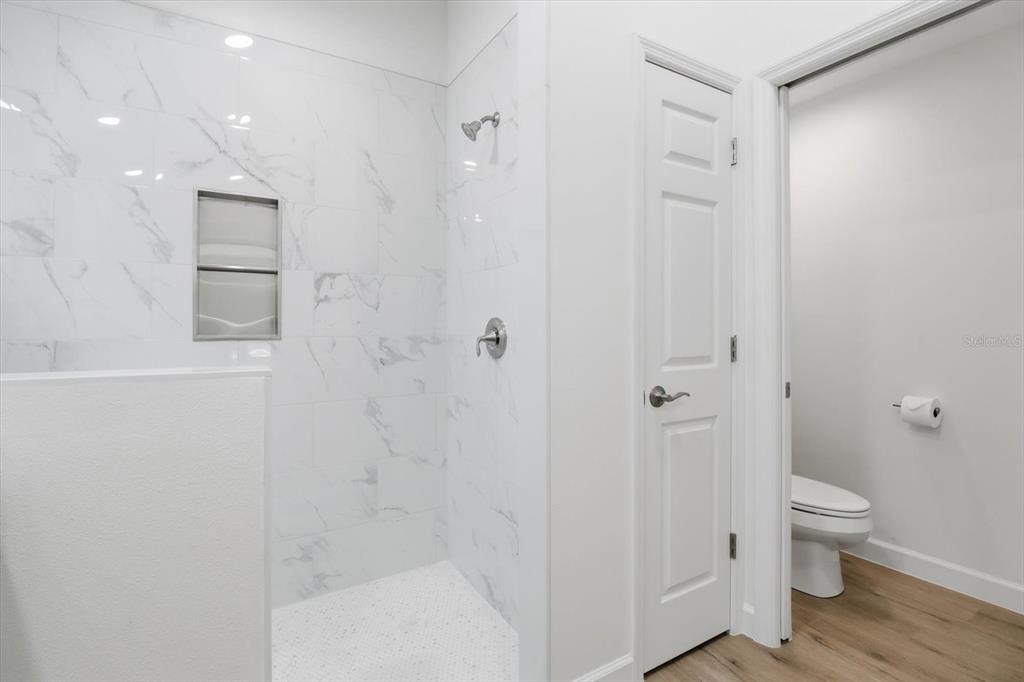 13418 Cormorant Road Weeki Wachee, FL 34614 - Photo 34 of 46 a bathroom with a toilet and a shower