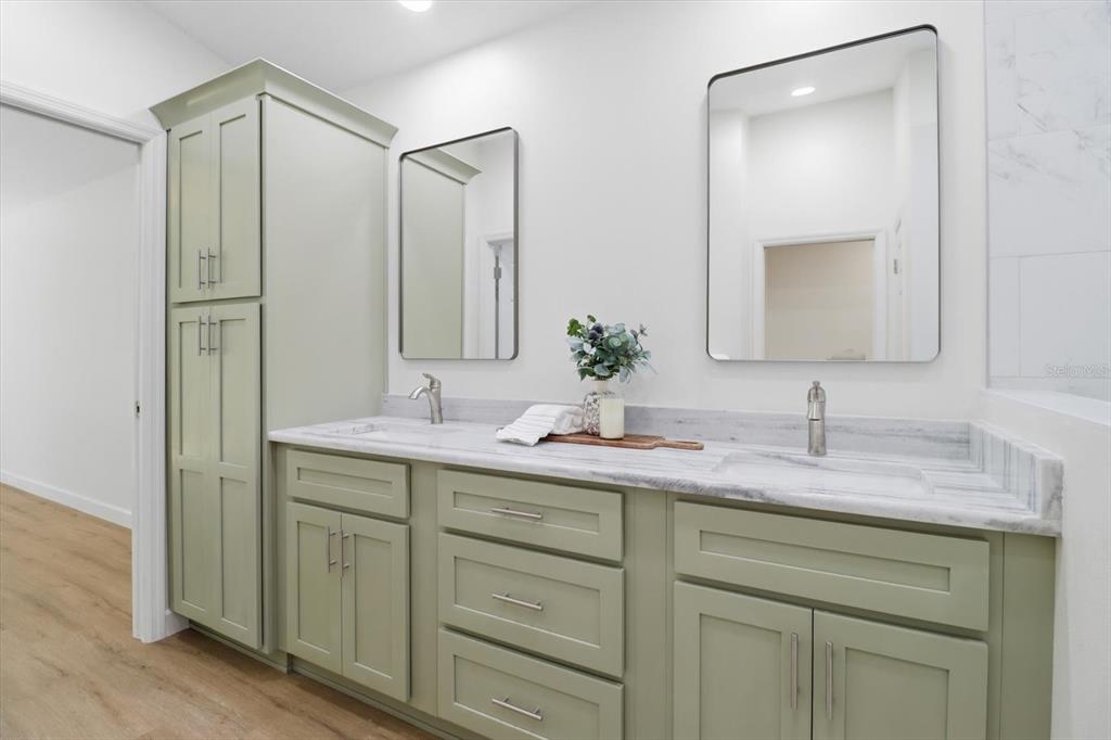 13418 Cormorant Road Weeki Wachee, FL 34614 - Photo 35 of 46 a bathroom with a double vanity sink and mirror