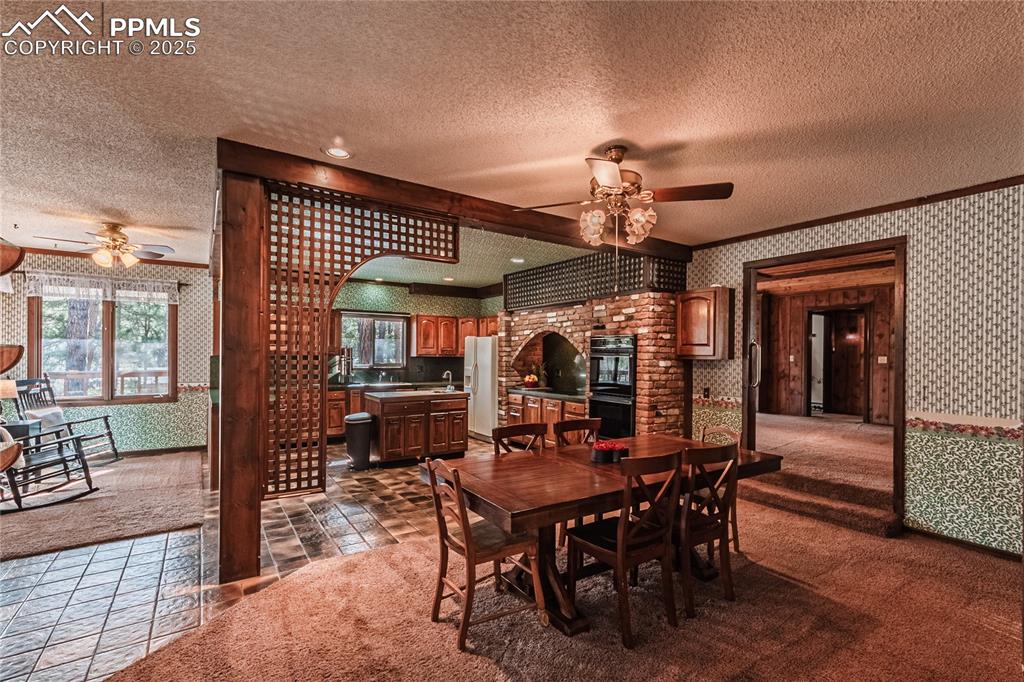 7190 Burgess Road Colorado Springs, CO 80908 - Photo 14 of 50 a view of a dining room with furniture and chandelier