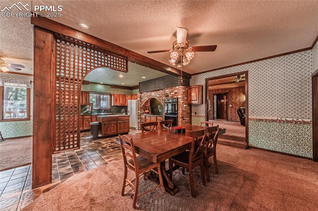 7190 Burgess Road Colorado Springs, CO 80908 - Photo 15 of 50 a view of a dining room with furniture