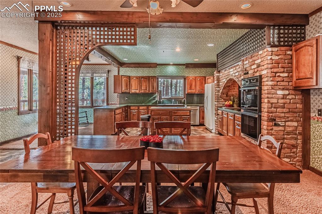 7190 Burgess Road Colorado Springs, CO 80908 - Photo 16 of 50 a dining room with a wooden table and chairs
