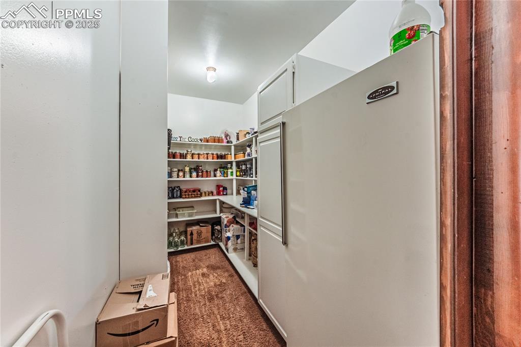 7190 Burgess Road Colorado Springs, CO 80908 - Photo 18 of 50 a view of walk in closet with clothes and shoes