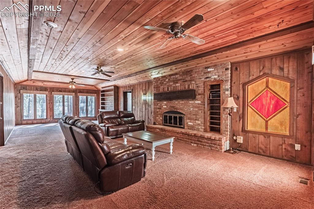 7190 Burgess Road Colorado Springs, CO 80908 - Photo 30 of 50 a living room with furniture a fireplace and a table
