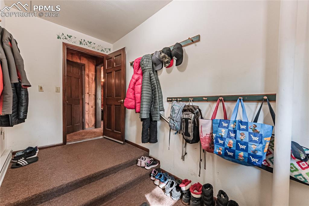 7190 Burgess Road Colorado Springs, CO 80908 - Photo 32 of 50 a view of walk in closet with clothes and shoes