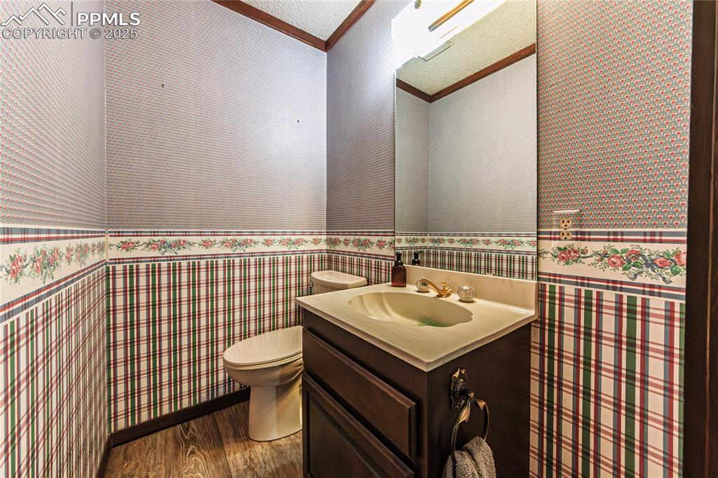 7190 Burgess Road Colorado Springs, CO 80908 - Photo 33 of 50 a bathroom with a sink and a toilet