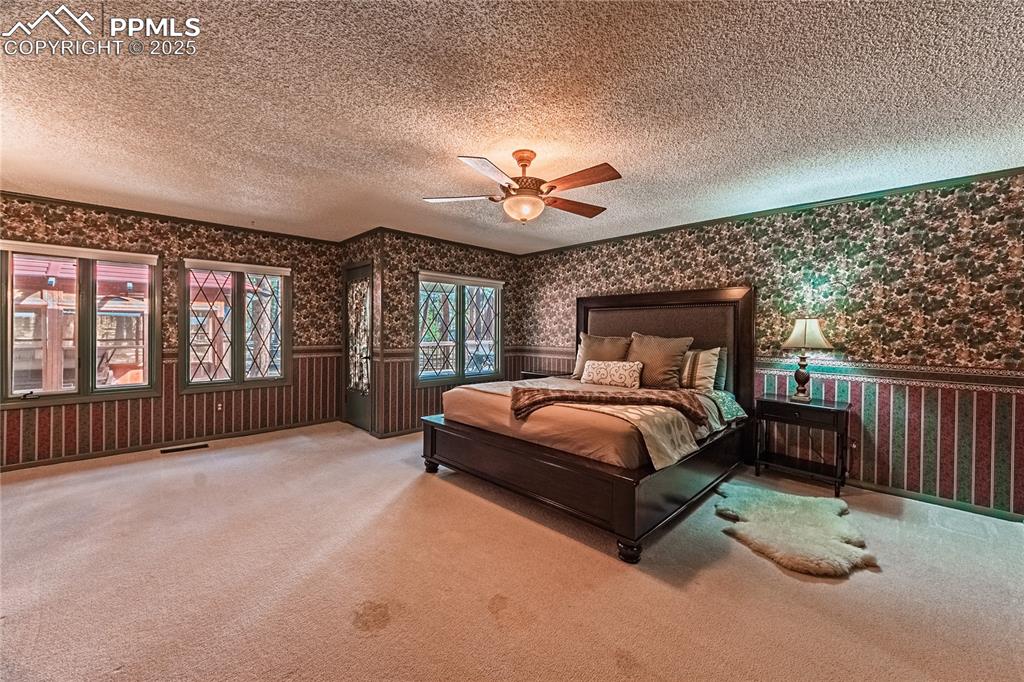 7190 Burgess Road Colorado Springs, CO 80908 - Photo 35 of 50 a bed sitting in a spacious bedroom next to a window