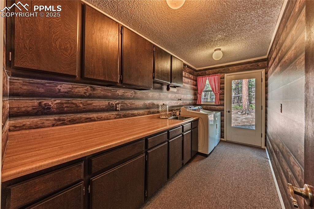 7190 Burgess Road Colorado Springs, CO 80908 - Photo 42 of 50 a kitchen with stainless steel appliances granite countertop wooden cabinets a sink and dishwasher