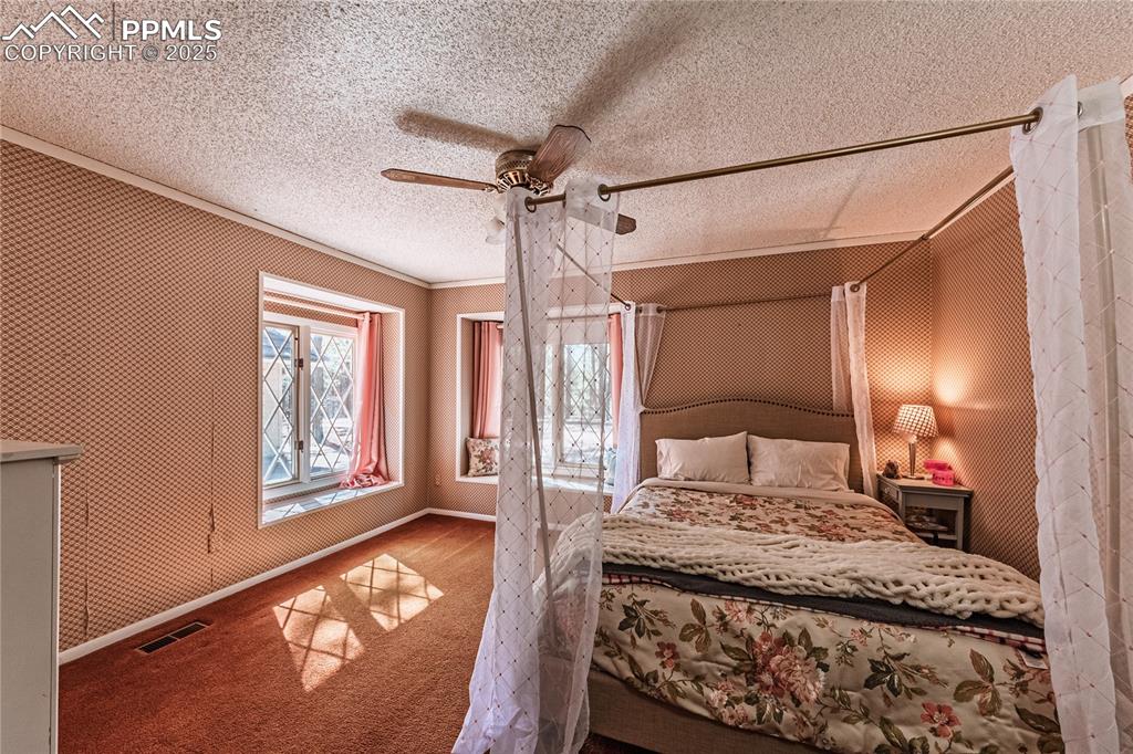 7190 Burgess Road Colorado Springs, CO 80908 - Photo 47 of 50 a bedroom with a large bed and a window
