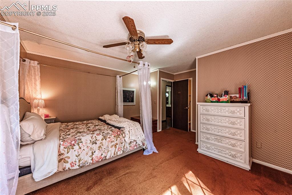 7190 Burgess Road Colorado Springs, CO 80908 - Photo 49 of 50 a bedroom with a bed and cabinets