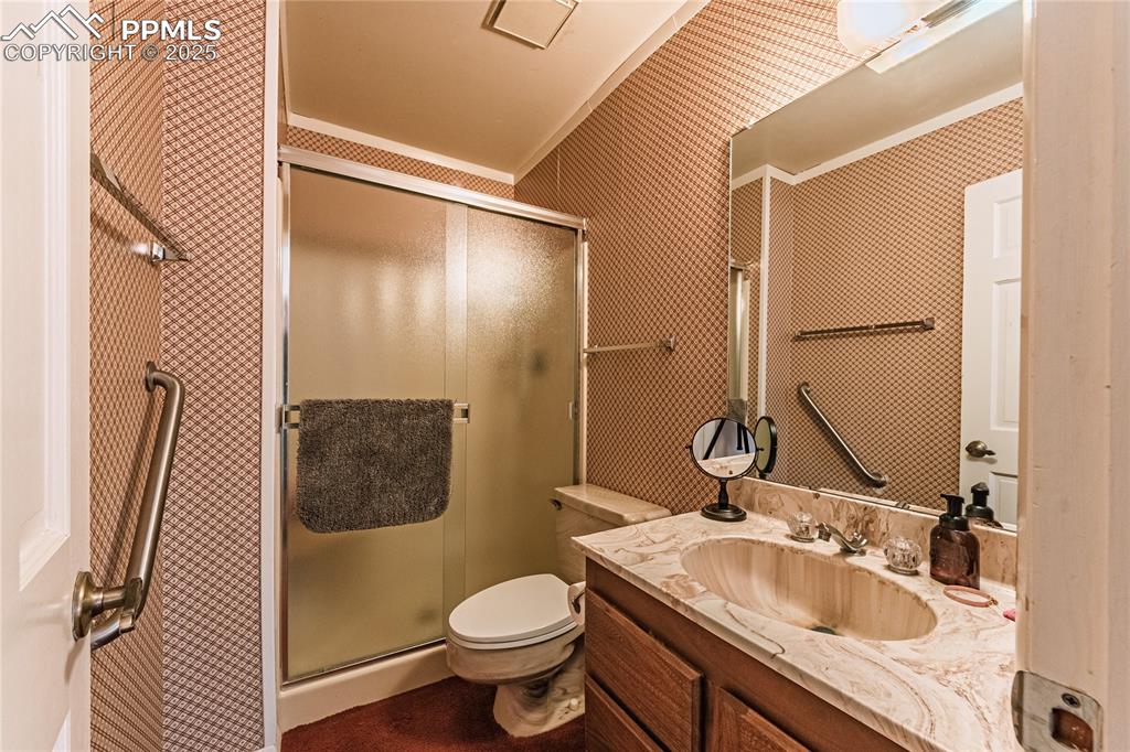 7190 Burgess Road Colorado Springs, CO 80908 - Photo 50 of 50 a bathroom with a sink toilet and shower