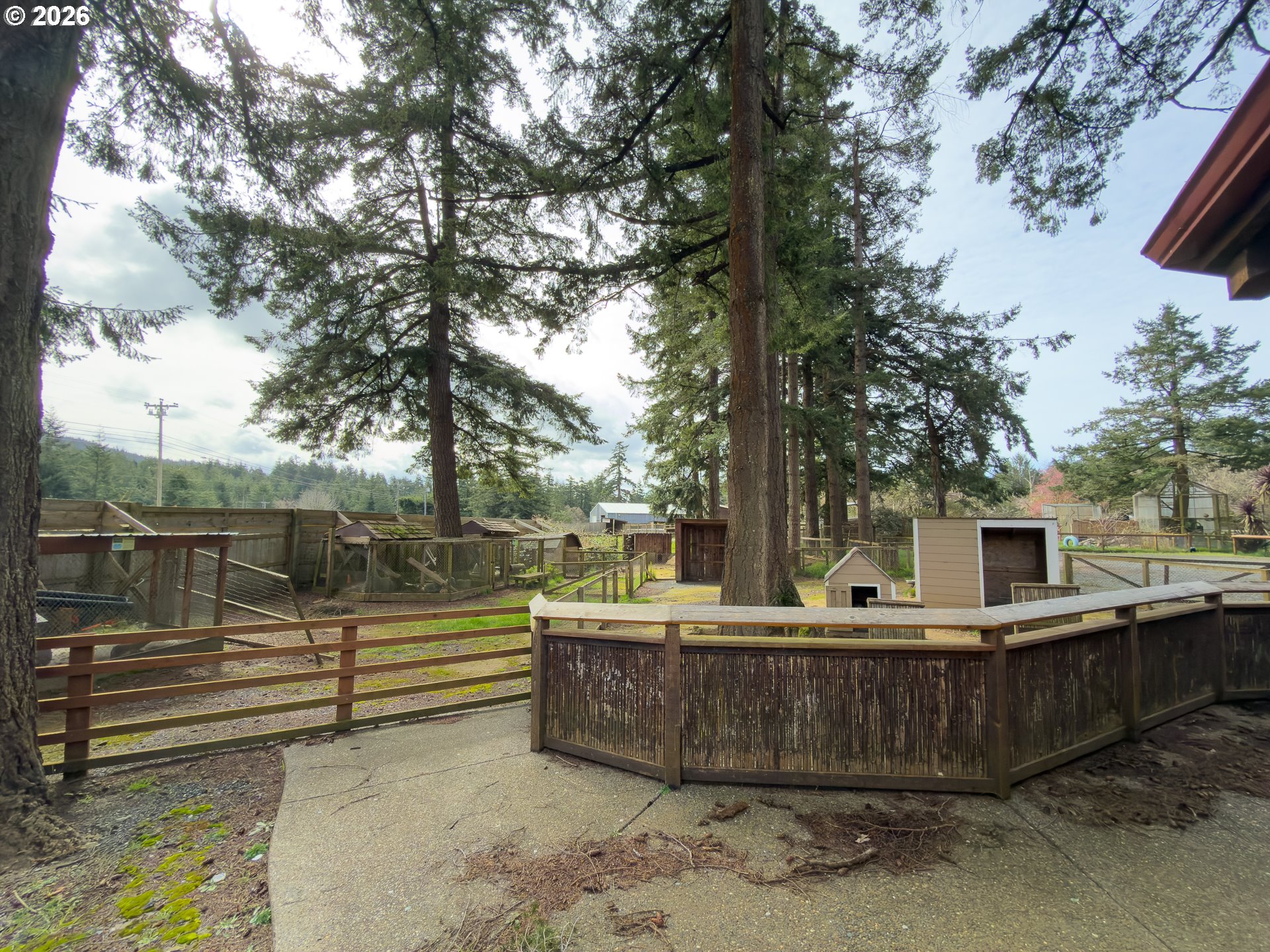 46914 Highway 101 Bandon, OR 97411 - Photo 18 of 48 a backyard of a house with barbeque oven and outdoor seating