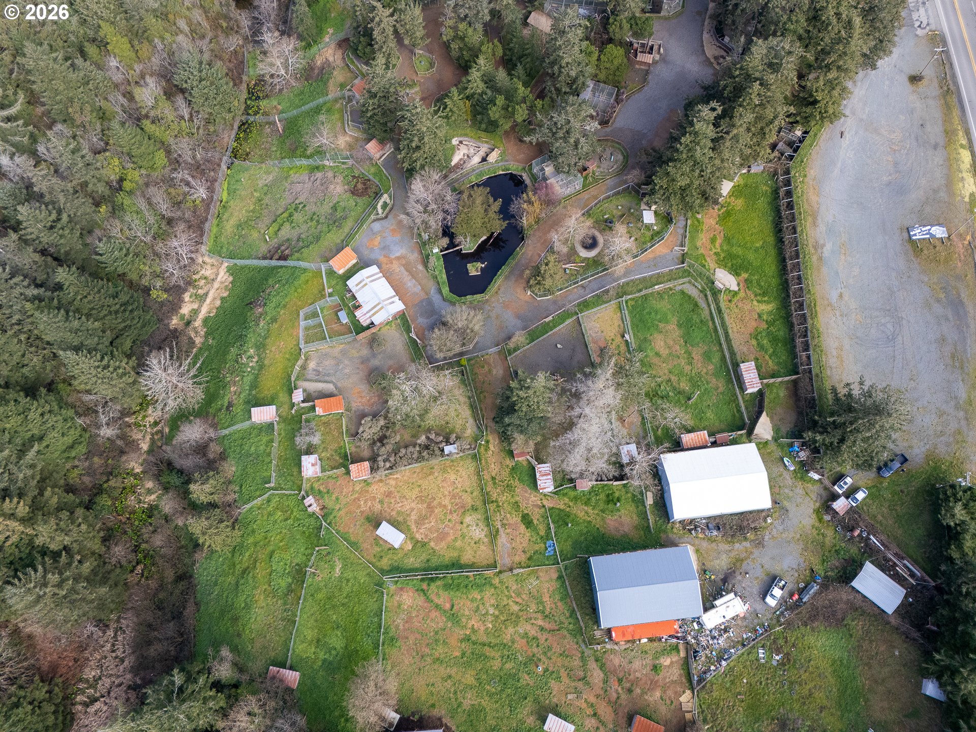 46914 Highway 101 Bandon, OR 97411 - Photo 27 of 48 an aerial view of a house with a yard basket ball court and outdoor seating
