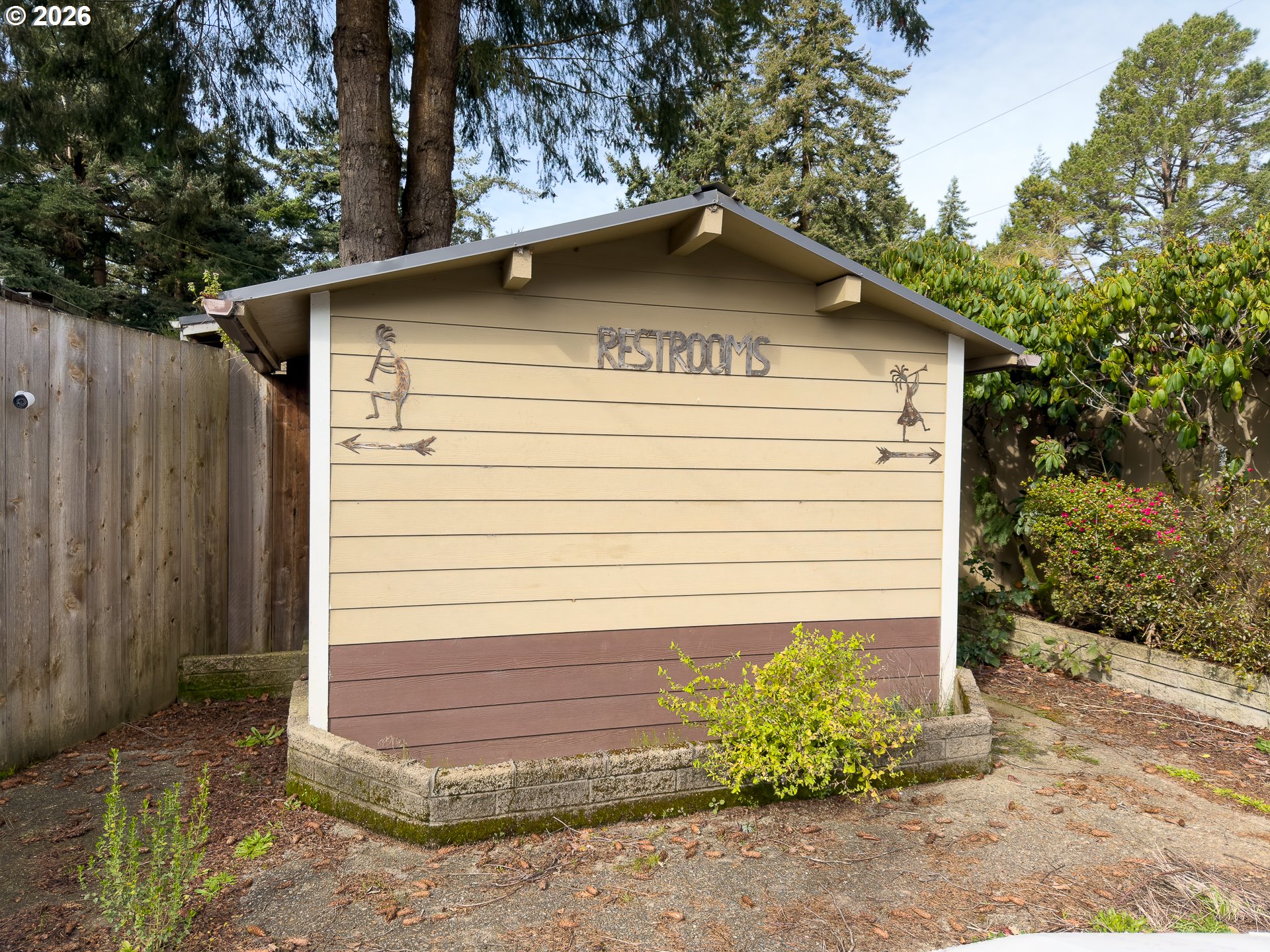 46914 Highway 101 Bandon, OR 97411 - Photo 32 of 48 a view of wooden house with a small yard plants and large trees