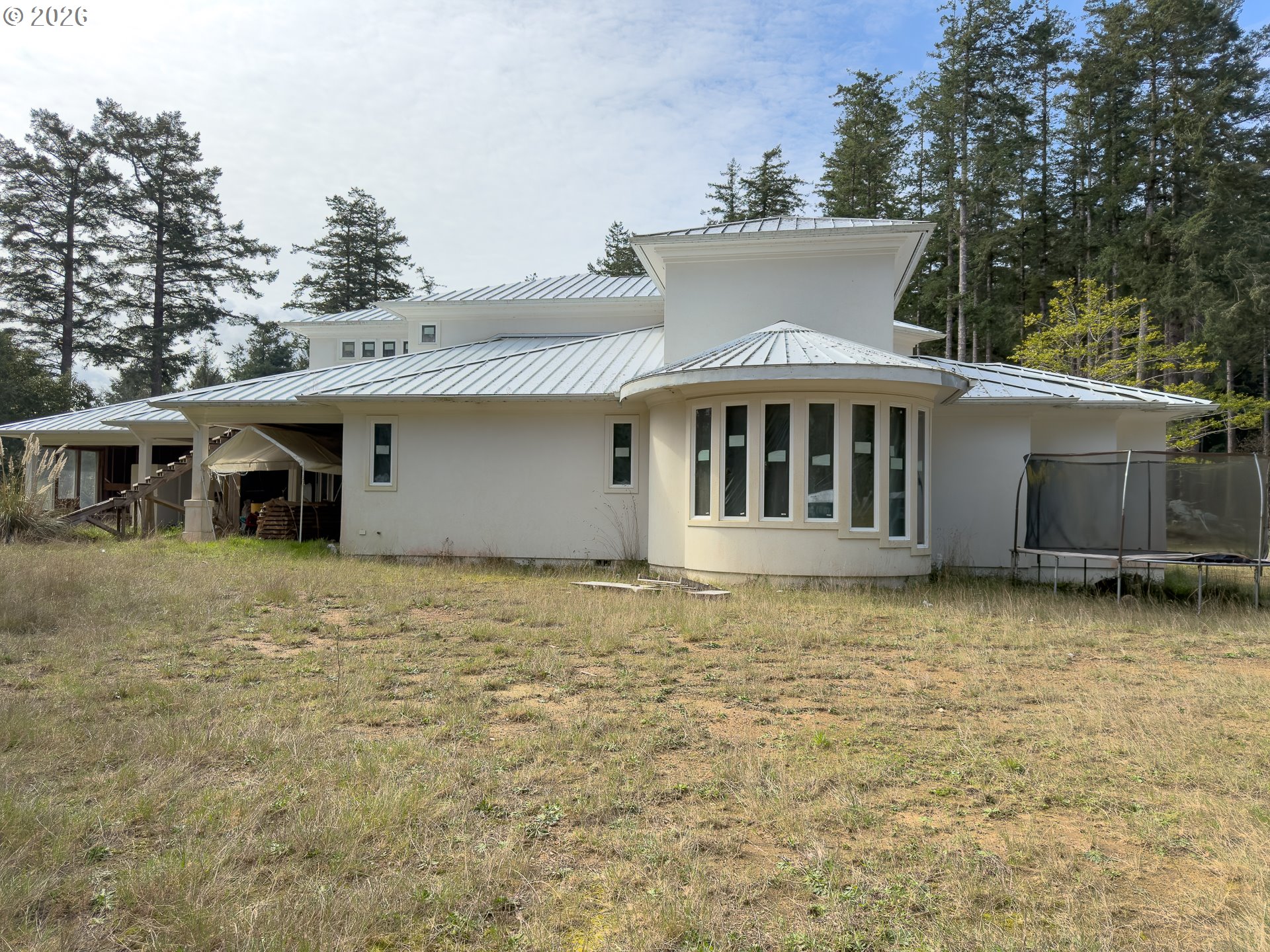 46914 Highway 101 Bandon, OR 97411 - Photo 39 of 48 a front view of a house with a garden