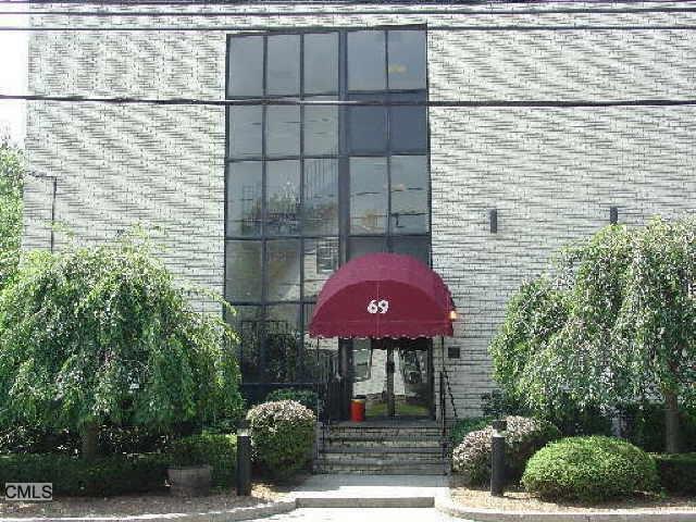 69 Cove Road, Unit B4 Stamford, CT 06902 - Photo 1 of 1 a front view of a house with a yard