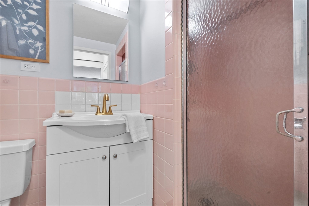 80 Park Street, Unit 23 Brookline, MA 02446 - Photo 22 of 38 a bathroom with a sink and a mirror
