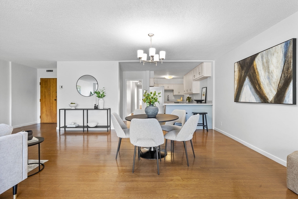 80 Park Street, Unit 23 Brookline, MA 02446 - Photo 9 of 38 a view of a dining room with furniture and wooden floor