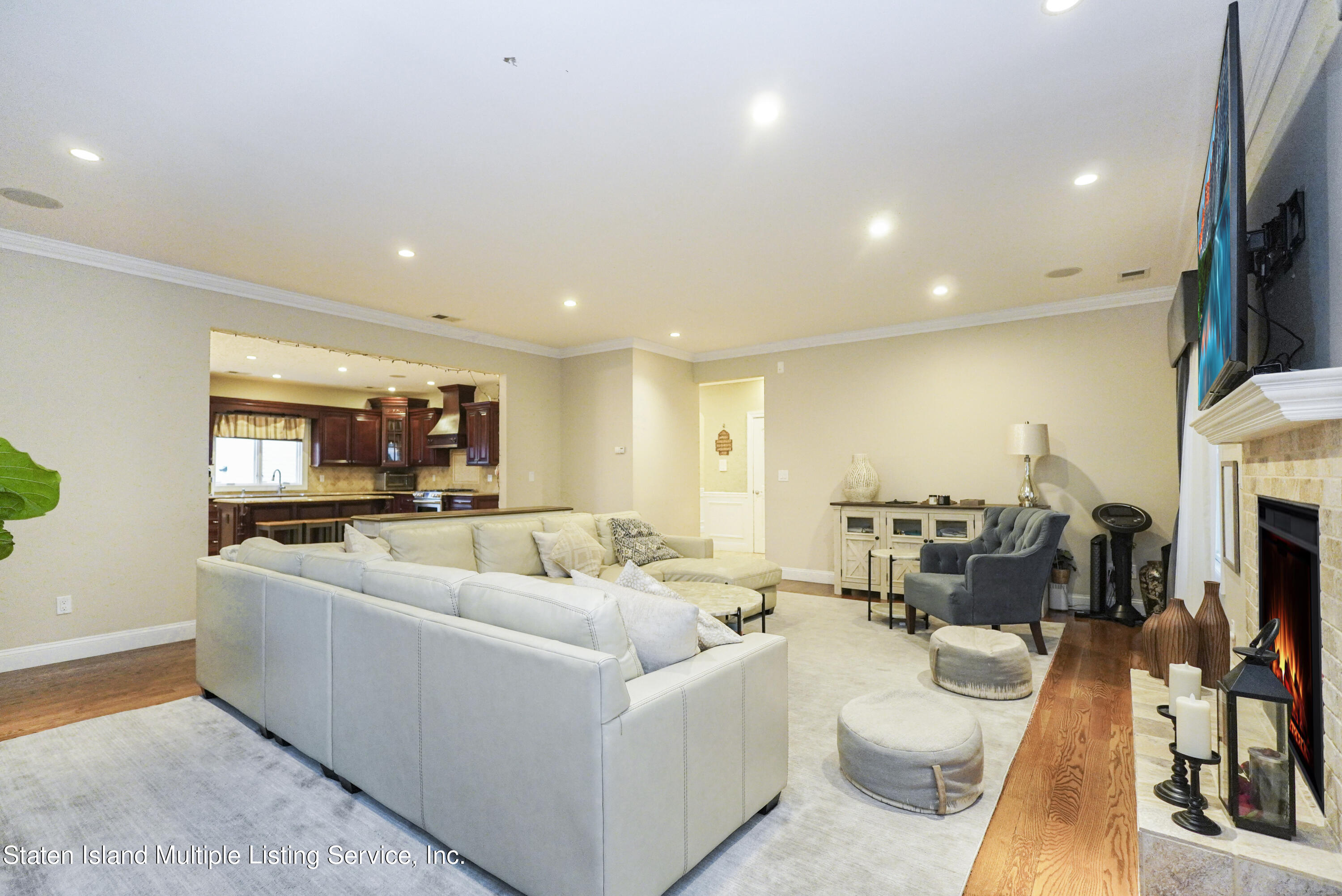 20 Kenneth Place Staten Island, NY 10309 - Photo 11 of 52 a living room with furniture a fireplace and a flat screen tv