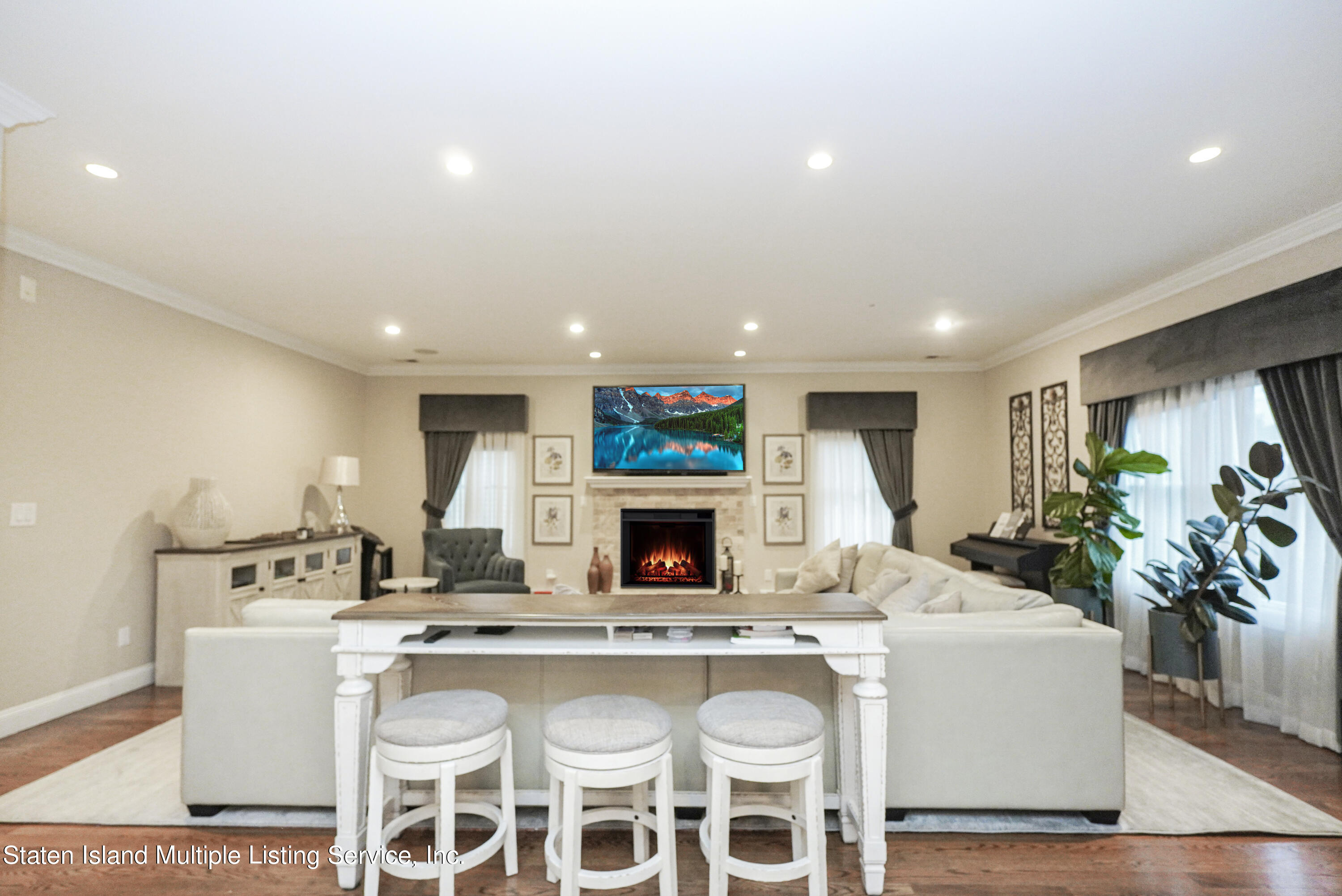 20 Kenneth Place Staten Island, NY 10309 - Photo 12 of 52 a living room with fireplace furniture a flat screen tv and a fireplace