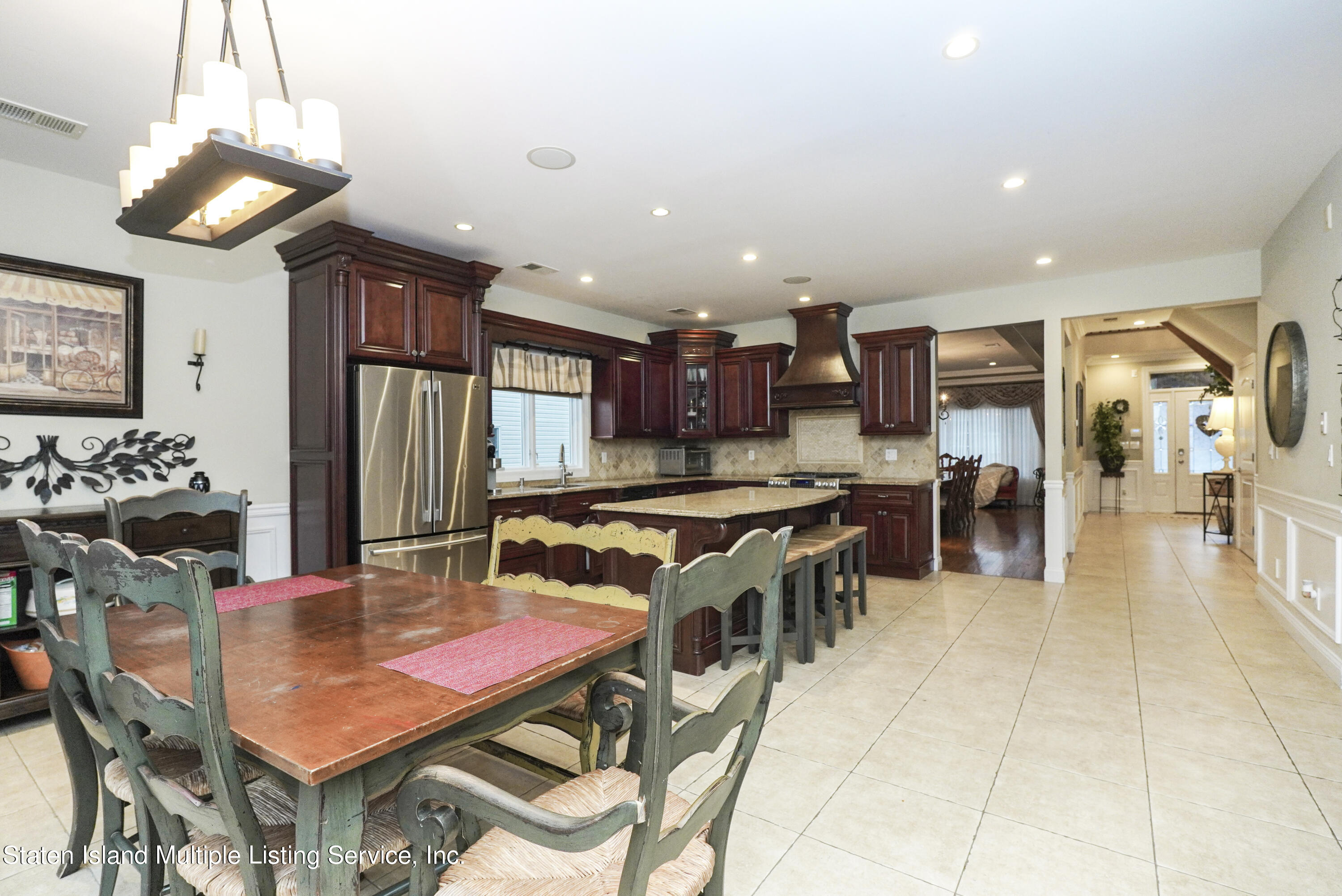 20 Kenneth Place Staten Island, NY 10309 - Photo 16 of 52 a kitchen with stainless steel appliances kitchen island granite countertop a table chairs and a refrigerator