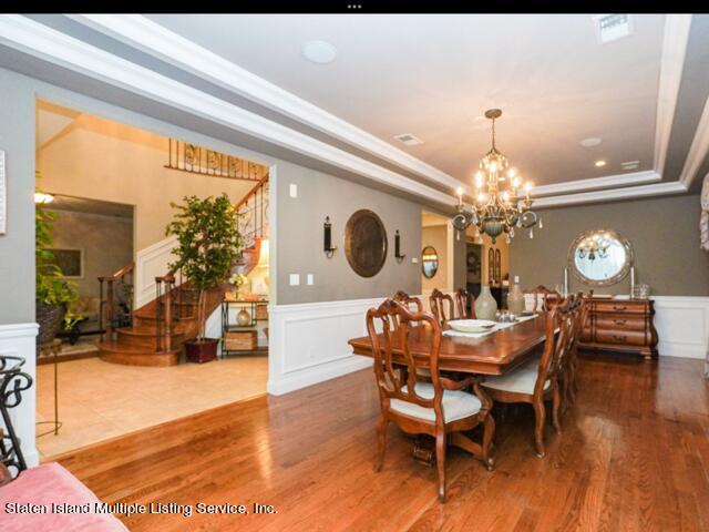 20 Kenneth Place Staten Island, NY 10309 - Photo 17 of 52 a dining room with furniture a chandelier and wooden floor