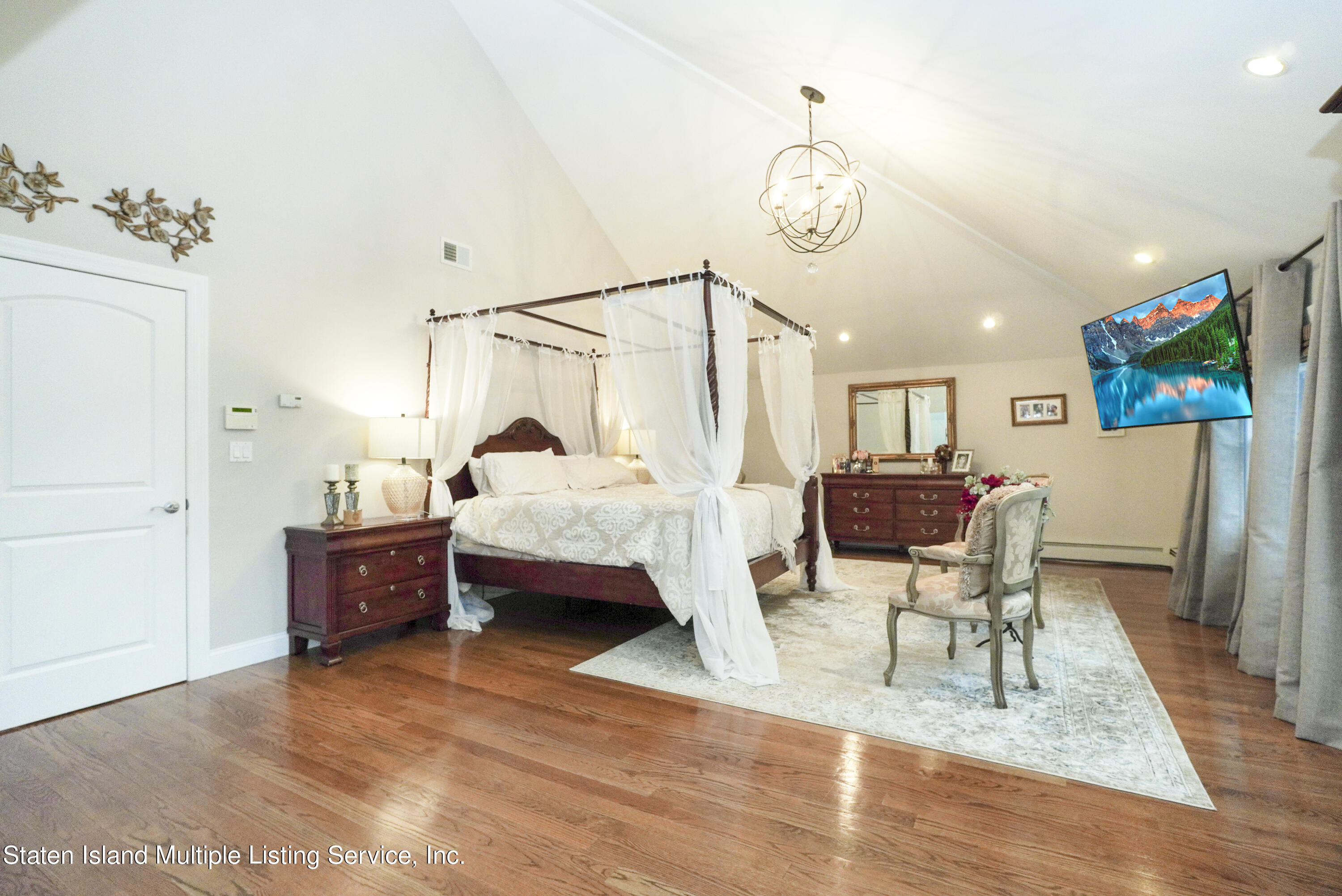 20 Kenneth Place Staten Island, NY 10309 - Photo 25 of 52 a bedroom with furniture and a wooden floor