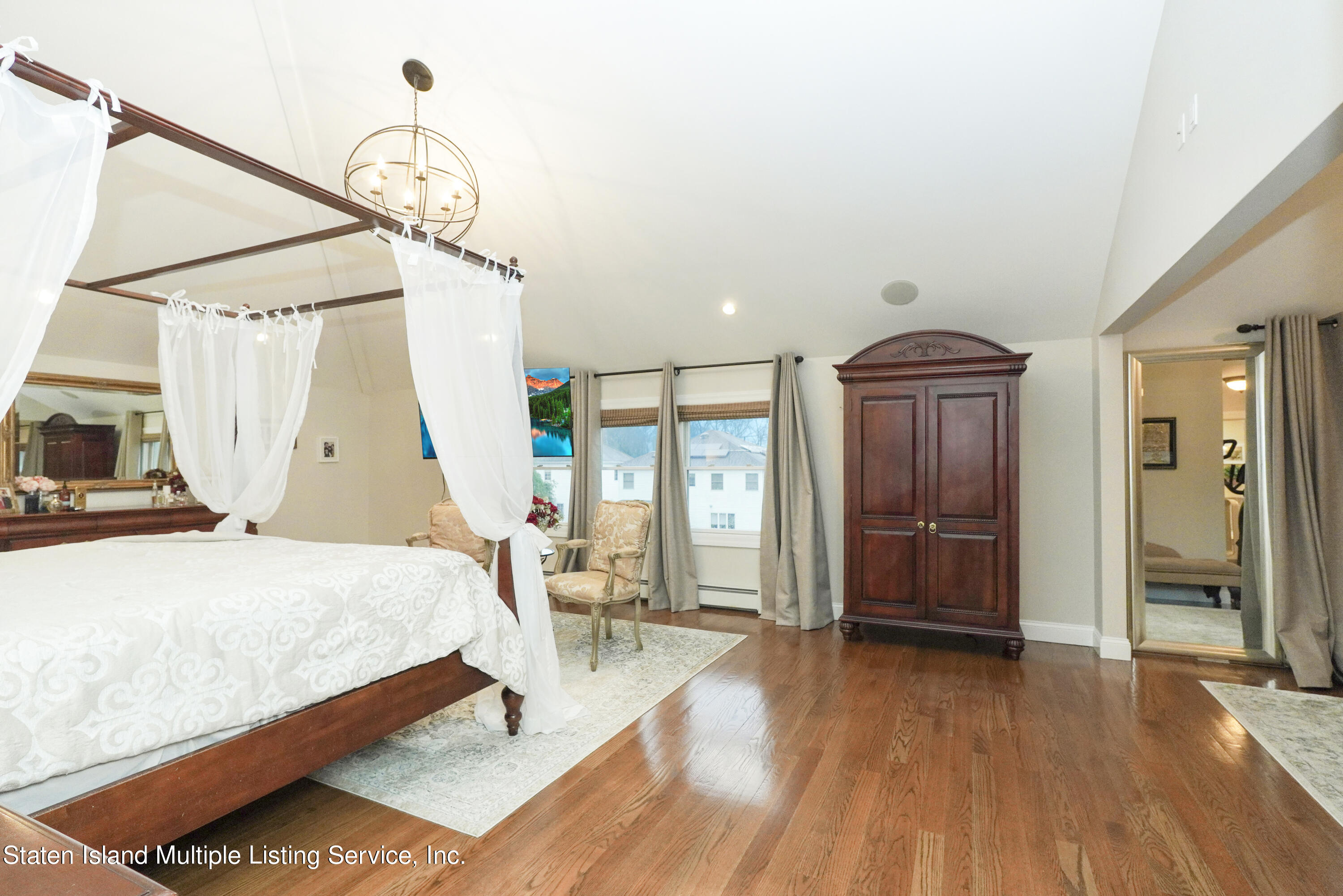 20 Kenneth Place Staten Island, NY 10309 - Photo 28 of 52 a spacious bedroom with a bed and wooden floor