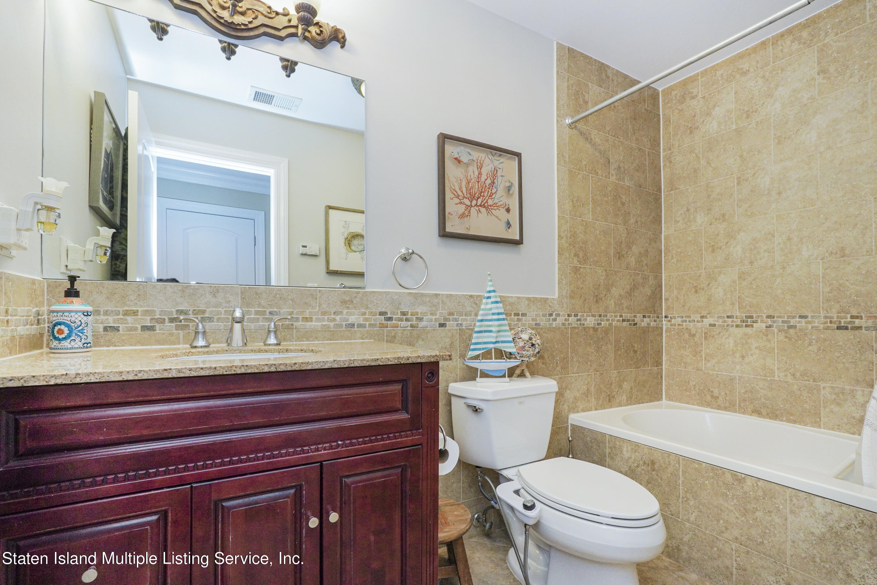 20 Kenneth Place Staten Island, NY 10309 - Photo 30 of 52 a bathroom with a granite countertop toilet sink and a mirror
