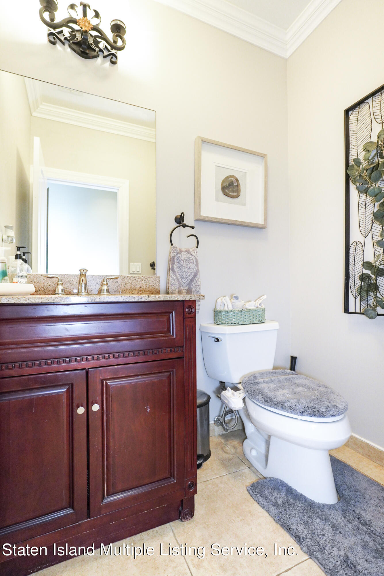 20 Kenneth Place Staten Island, NY 10309 - Photo 31 of 52 a bathroom with a toilet a sink and mirror