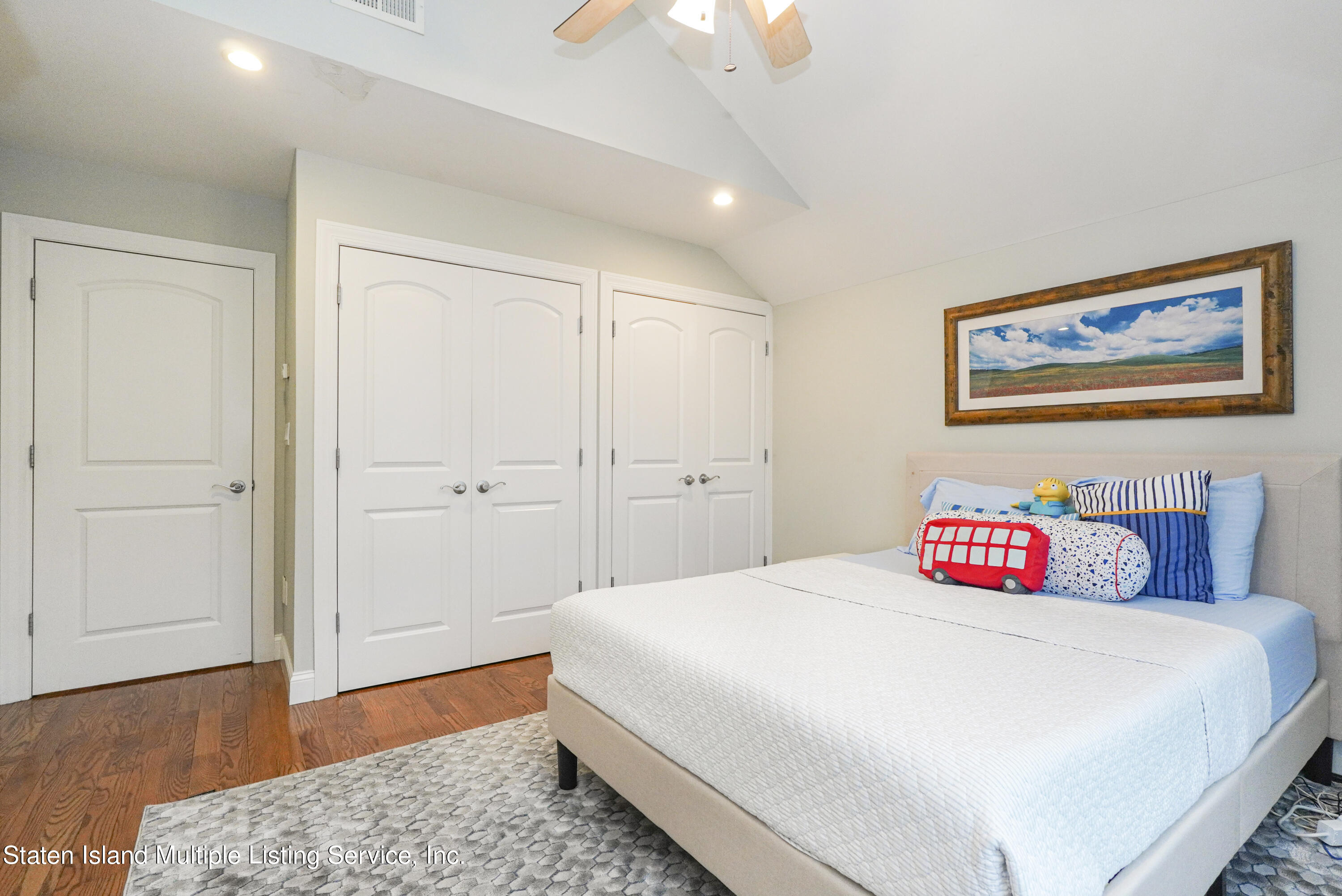 20 Kenneth Place Staten Island, NY 10309 - Photo 35 of 52 a bedroom with a bed and a wooden floor