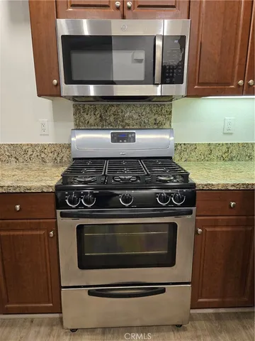 a stove top oven sitting inside of a kitchen