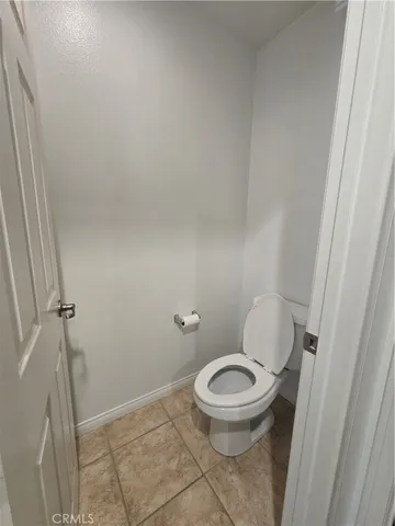 a white toilet sitting next to a shower