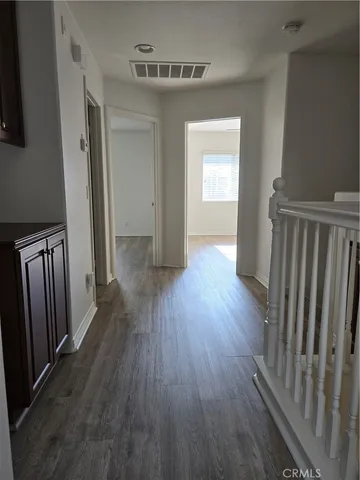 a view of entryway and hall with wooden floor