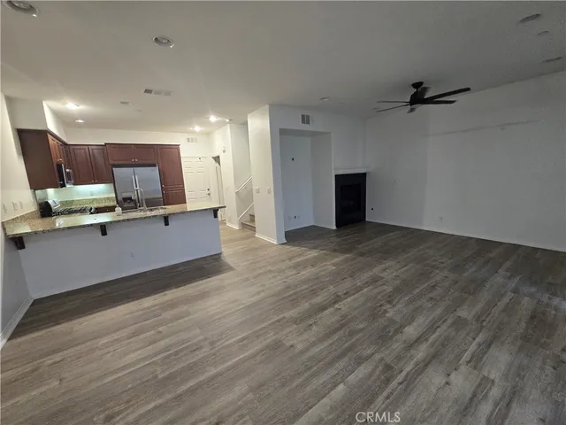 a view of kitchen with wooden floor and electronic appliances