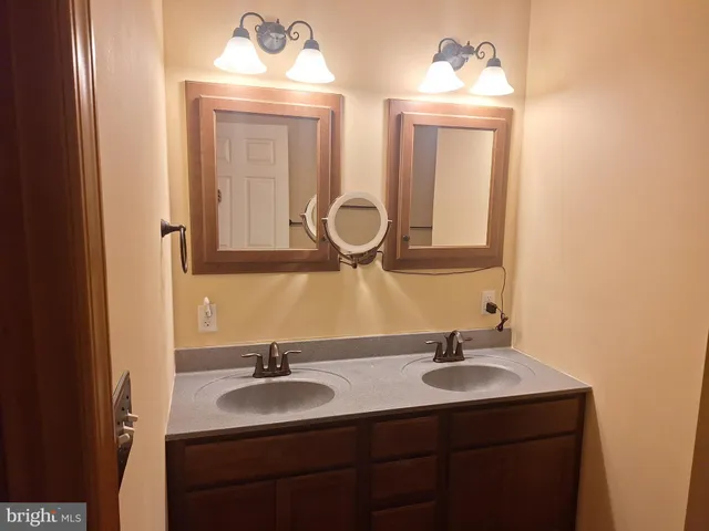 a bathroom with a double vanity sink and a mirror
