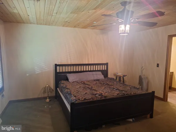 a bed sitting in a bedroom next to a window