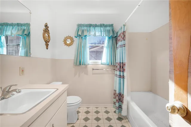 a bathroom with a sink a toilet and bathtub