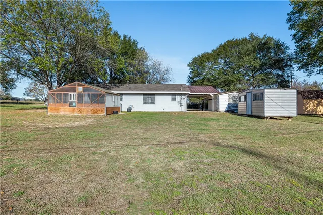 a view of a house with a yard and sitting area