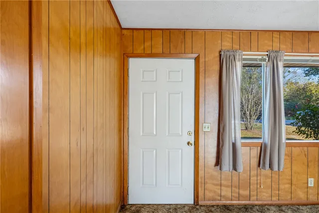 a view of a bathroom with a wooden door