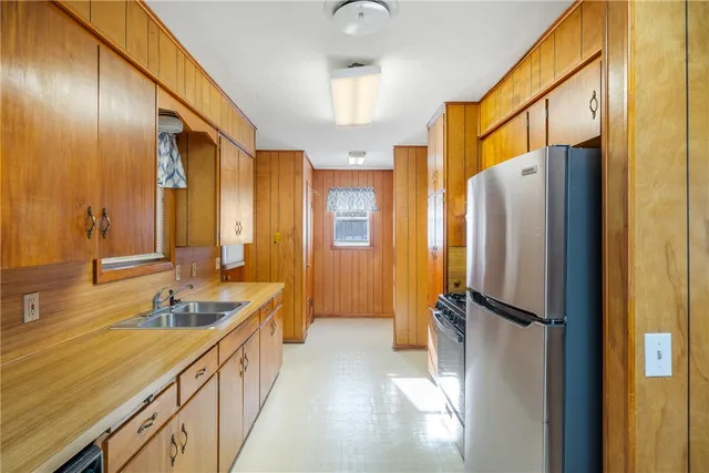 a bathroom with a double vanity sink a mirror and a shower