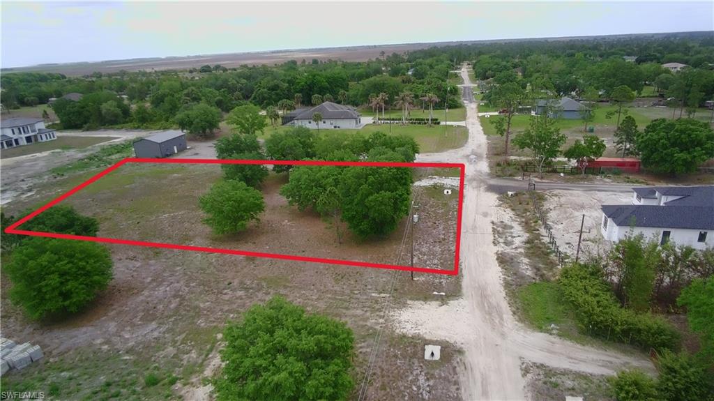 7860 3rd Terrace Lehigh Acres, FL 33936 - Photo 1 of 1 a view of park with large trees and playing ground