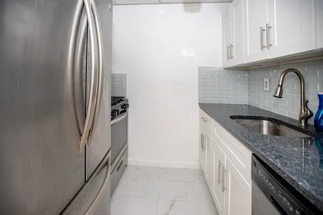 a stove top oven sitting inside of a kitchen