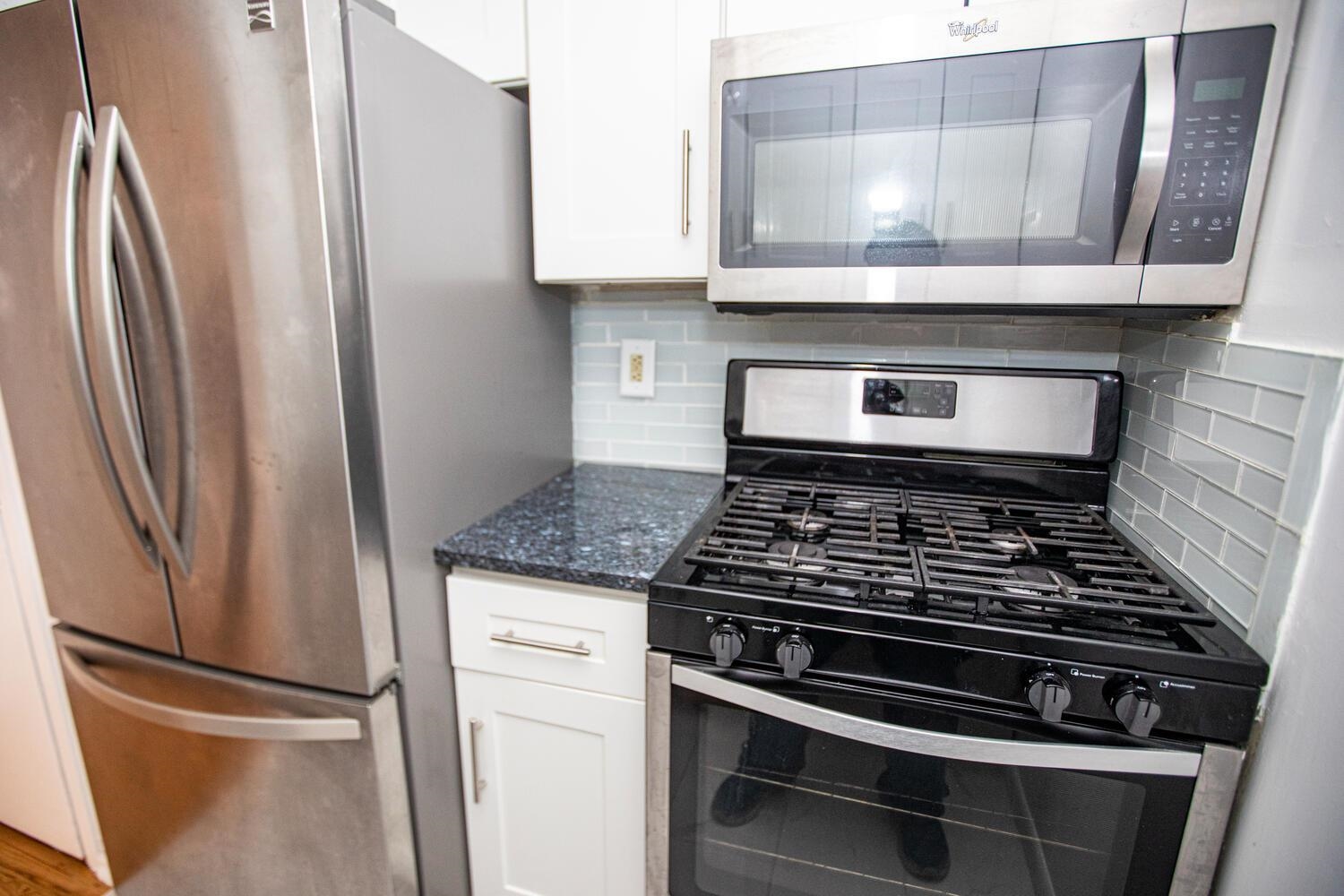 341 Monmouth Street, Unit 203D Jersey City, NJ 07302 - Photo 8 of 23 a stove top oven sitting inside of a kitchen