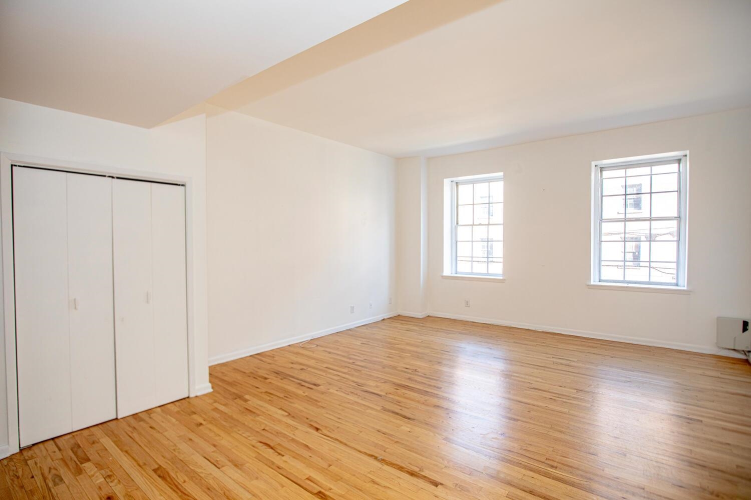 341 Monmouth Street, Unit 203D Jersey City, NJ 07302 - Photo 9 of 23 a view of empty room with wooden floor and fan