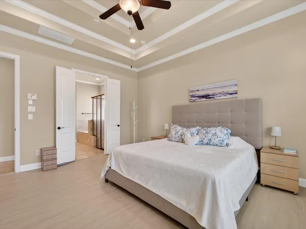 a bedroom with a bed and a chandelier