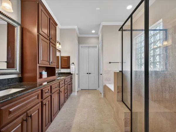 a bathroom with a large mirror and a shower