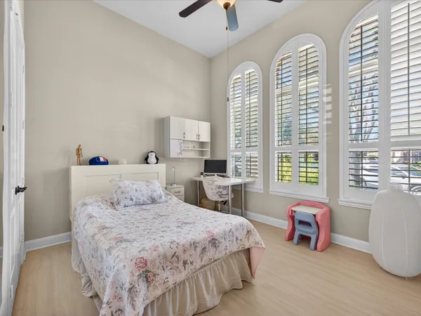 a bedroom with a bed and a large window