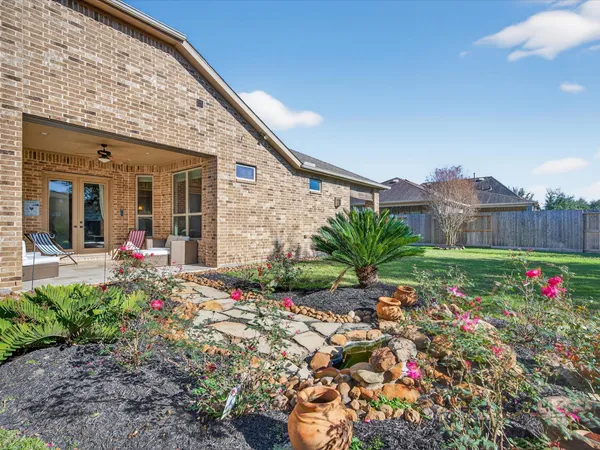 a front view of a house with a big yard and potted plants