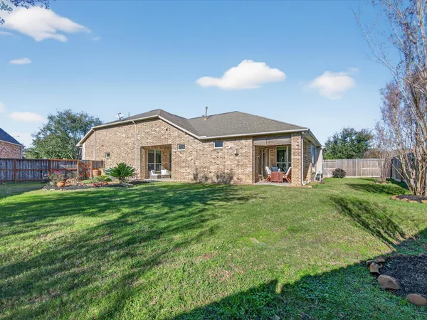 a view of a house with a yard and a garden